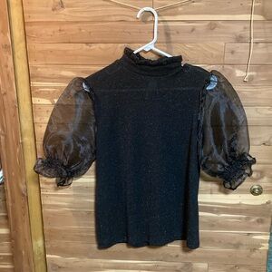 Black and metallic shirt with sheer short sleeves.